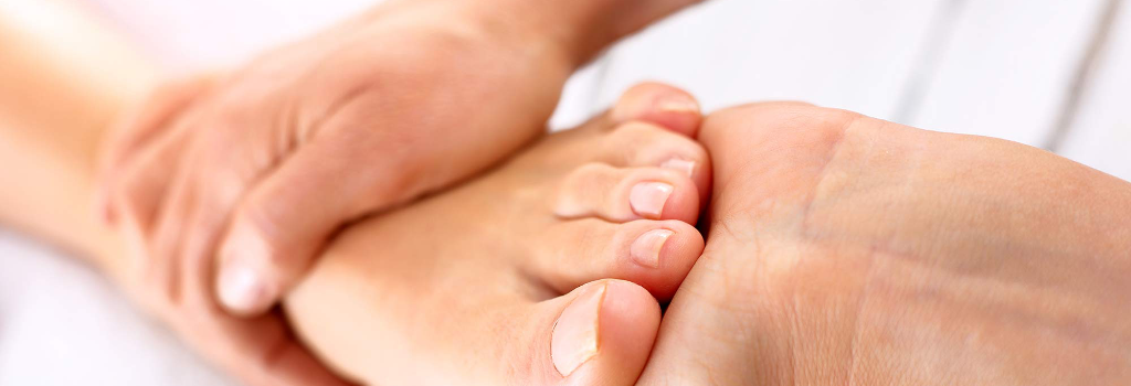 A healthcare professional examines the foot of a patient